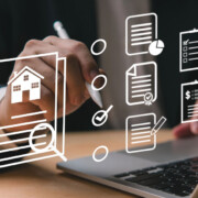 Ein Immobilienkaufinteressent geht an seinem Laptop seine Checkliste für den Immobilienverkauf durch | Checkliste Immobilienkauf